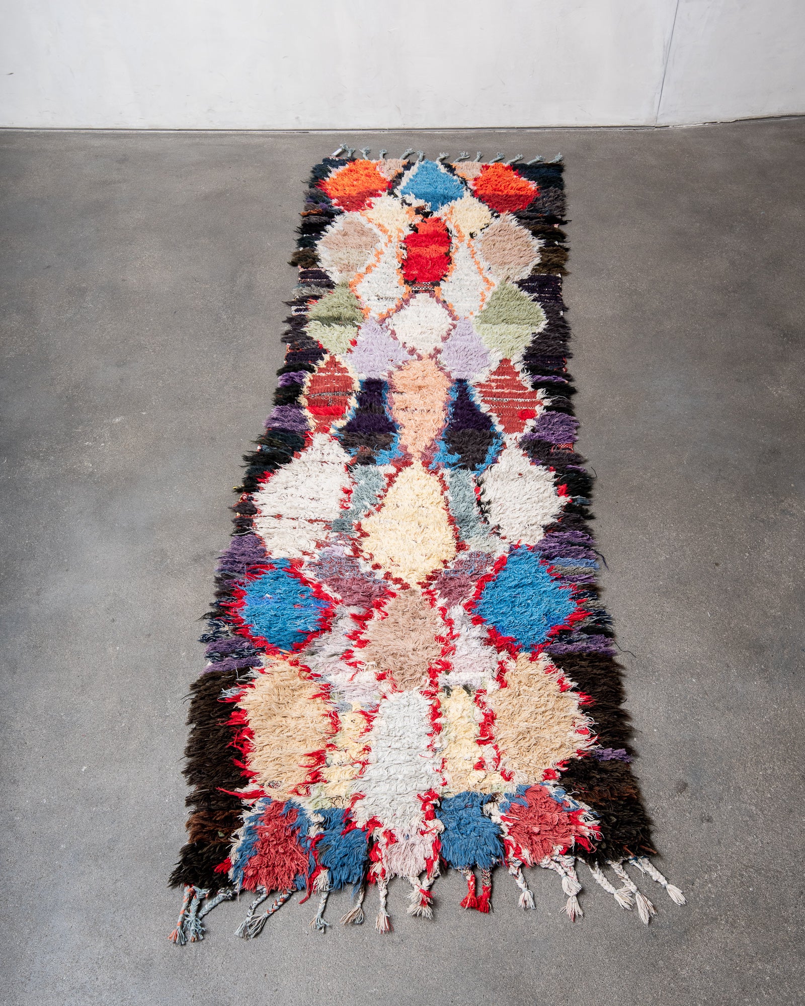 Modern designer vintage handcrafted cotton Berber rug from Morocco. Boucherouite with beautiful colors and patterns.